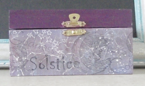 outside of box covered in stary scrapbook paper stamped with solstice and moons